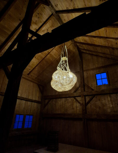 Woven light sculpture, reed, wood and a touch of brass